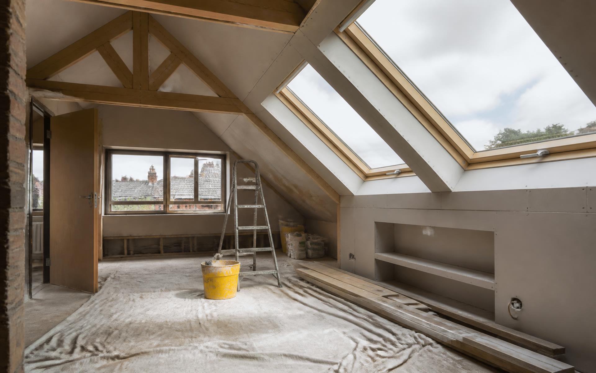 Loft space being converted with new roof windows and plasterboard